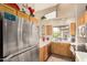 Bright kitchen featuring stainless steel refrigerator, and view of the backyard at 10301 N 70Th St # 223, Paradise Valley, AZ 85253