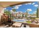 Balcony view of community pool with seating, palm trees, and well-maintained landscaping at 10301 N 70Th St # 223, Paradise Valley, AZ 85253