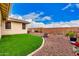 Picturesque backyard showcasing artificial turf, rock landscaping, and an inviting fire pit area for outdoor enjoyment at 10545 E Texas Ave, Mesa, AZ 85212