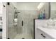 Shower features glass door, bench, and gray tile, with vanity just outside at 10545 E Texas Ave, Mesa, AZ 85212
