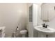 Bright half bath featuring a pedestal sink, tiled floors, and minimalist decor at 10545 E Texas Ave, Mesa, AZ 85212