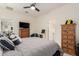 Bedroom featuring natural wood furniture, a large TV, and a neutral color scheme at 10545 E Texas Ave, Mesa, AZ 85212