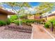 Serene common area features lush landscaping, walking paths, and seating, offering a peaceful outdoor retreat at 10545 E Texas Ave, Mesa, AZ 85212