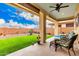 Inviting covered patio offers comfortable seating and an outdoor view, perfect for relaxation and enjoying the backyard at 10545 E Texas Ave, Mesa, AZ 85212