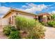 Charming single-story home featuring a two-car garage and welcoming front porch with mature landscaping at 10545 E Texas Ave, Mesa, AZ 85212