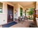 Inviting front porch seating area with charming decor and decorative security door at 10545 E Texas Ave, Mesa, AZ 85212