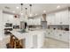 Modern kitchen featuring a large island, stainless steel appliances, and pendant lighting at 10545 E Texas Ave, Mesa, AZ 85212