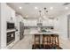 Bright kitchen boasts a large island, white cabinets, stainless steel appliances, and stylish lighting at 10545 E Texas Ave, Mesa, AZ 85212