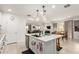 Open concept kitchen with a large island, stainless appliances, and seamless flow to dining and living areas at 10545 E Texas Ave, Mesa, AZ 85212