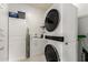 Bright laundry room features stacked washer and dryer units, built-in cabinets, and ample storage solutions for convenience at 10545 E Texas Ave, Mesa, AZ 85212