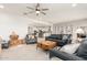 Bright and open living room with ample seating, flowing into the kitchen and dining area at 10545 E Texas Ave, Mesa, AZ 85212