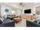 Spacious living room with neutral tones, tile floors, ceiling fan, and plenty of natural light at 10545 E Texas Ave, Mesa, AZ 85212