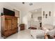 Inviting living room with wood cabinet, cozy chaise lounge, and neutral decor at 10545 E Texas Ave, Mesa, AZ 85212