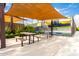 Outdoor picnic area featuring shaded seating and tennis court views for relaxing and enjoying community amenities at 10545 E Texas Ave, Mesa, AZ 85212