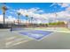 Well-maintained tennis court with blue playing surface, offering an active and social lifestyle at 10545 E Texas Ave, Mesa, AZ 85212