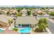 Aerial view showcases backyard with a refreshing private pool, complemented by desert landscaping, and inviting patio area at 10760 W Encanto Blvd, Avondale, AZ 85392