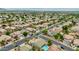 Sprawling aerial shot showcases a vibrant neighborhood with diverse home styles, green spaces, and convenient access to amenities at 10760 W Encanto Blvd, Avondale, AZ 85392