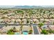 Panoramic aerial shot of a community offering diverse housing options, tree-lined streets, and a picturesque lake in the distance at 10760 W Encanto Blvd, Avondale, AZ 85392
