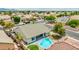 Aerial view of backyard featuring a sparkling blue private pool, manicured lawn, and ample space for outdoor enjoyment at 10760 W Encanto Blvd, Avondale, AZ 85392