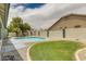 Backyard featuring a refreshing kidney-shaped pool, low maintenance yard, grassy area and mature trees at 10760 W Encanto Blvd, Avondale, AZ 85392
