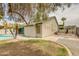 A backyard with a covered patio, palm trees, and a swimming pool offers outdoor relaxation and entertainment at 10760 W Encanto Blvd, Avondale, AZ 85392
