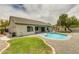 Backyard featuring a refreshing kidney-shaped pool, low maintenance yard, grassy area and covered patio at 10760 W Encanto Blvd, Avondale, AZ 85392
