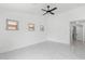 Sun-drenched bedroom showcasing marble floors, a ceiling fan, and three large windows at 10760 W Encanto Blvd, Avondale, AZ 85392