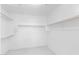 Walk-in closet with white walls, marble floors, and wood shelving at 10760 W Encanto Blvd, Avondale, AZ 85392