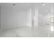 A spacious and clean empty room featuring sleek marble floors and neutral walls, ready for customization at 10760 W Encanto Blvd, Avondale, AZ 85392