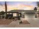 Home's facade features desert landscaping, architectural details, and well-lit exterior for evening appeal at 10760 W Encanto Blvd, Avondale, AZ 85392