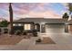 Home's facade features desert landscaping, architectural details, and well-lit exterior for evening appeal at 10760 W Encanto Blvd, Avondale, AZ 85392