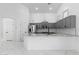 Open kitchen with stainless steel appliances, gray cabinets, granite countertops, and modern pendant lighting at 10760 W Encanto Blvd, Avondale, AZ 85392