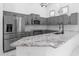 Bright kitchen featuring gray cabinets, stainless steel appliances, granite countertops and stylish pendant lighting at 10760 W Encanto Blvd, Avondale, AZ 85392