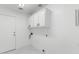 Bright laundry room with white cabinets, appliances, and marble floors at 10760 W Encanto Blvd, Avondale, AZ 85392