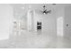 Open-concept living room with marble floors, a ceiling fan, and views of the kitchen at 10760 W Encanto Blvd, Avondale, AZ 85392