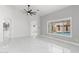 Neutral living room with marble floors, natural lighting, and a view of the backyard pool at 10760 W Encanto Blvd, Avondale, AZ 85392