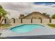 Backyard featuring a refreshing kidney-shaped pool, low maintenance yard, block wall, and patio space at 10760 W Encanto Blvd, Avondale, AZ 85392