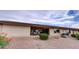 Rear exterior view showcasing a covered patio, well-maintained yard, and roll-down sunshades at 11069 E Kilarea Ave # 194, Mesa, AZ 85209
