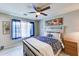 Bright bedroom with a queen-sized bed, a ceiling fan, and neutral palette at 11069 E Kilarea Ave # 194, Mesa, AZ 85209