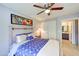Cozy bedroom featuring soft lighting, queen size bed, and view of ensuite bathroom at 11069 E Kilarea Ave # 194, Mesa, AZ 85209