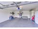 Spacious garage featuring speckled epoxy flooring and ample storage space at 11069 E Kilarea Ave # 194, Mesa, AZ 85209