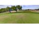 Scenic golf course view showcasing manicured greens and distant mountain views at 11069 E Kilarea Ave # 194, Mesa, AZ 85209