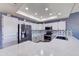 Bright kitchen featuring white cabinetry, stainless appliances and a unique backsplash at 11069 E Kilarea Ave # 194, Mesa, AZ 85209