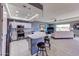 Open kitchen and living area with a breakfast bar and stainless steel appliances at 11069 E Kilarea Ave # 194, Mesa, AZ 85209