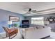 Cozy living room with natural light, ceiling fan, and comfortable couch at 11069 E Kilarea Ave # 194, Mesa, AZ 85209