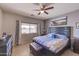 Bright bedroom with a comfortable king-sized bed, and a ceiling fan at 11069 E Kilarea Ave # 194, Mesa, AZ 85209
