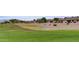 Picturesque neighborhood view featuring lush golf course views and mature shade trees at 11069 E Kilarea Ave # 194, Mesa, AZ 85209