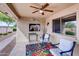 Relaxing covered patio featuring comfortable seating, decorative art and beautiful outdoor views at 11069 E Kilarea Ave # 194, Mesa, AZ 85209