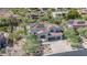 Aerial view of the property with a tile roof, and three-car garage at 11446 E Sweetwater Ave, Scottsdale, AZ 85259
