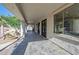 Spacious covered patio with tile flooring, pillars, and lush landscaping at 11446 E Sweetwater Ave, Scottsdale, AZ 85259